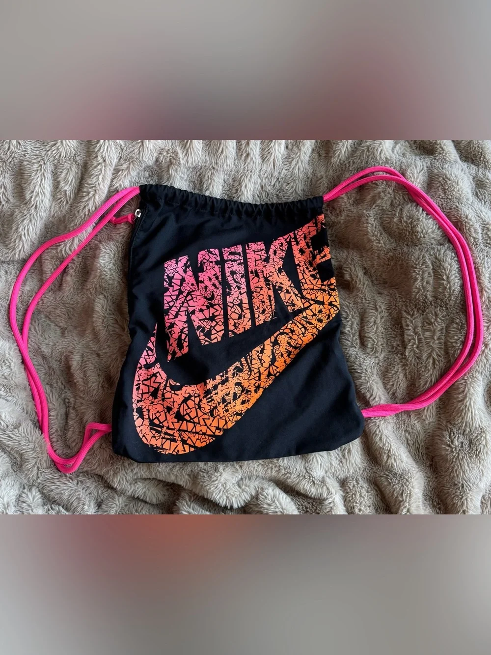Nike Black Drawstring Backpack with Pink-to-Orange Gradient Logo